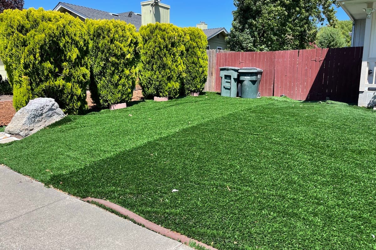 Installed artificial turf yard, one flat uniform green with a hard paver edge